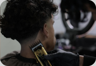 A Coffee & Cutz barber cutting a student’s hair