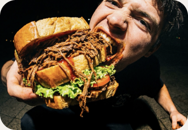 A Phat Buns customer taking on an oversized loaded bun