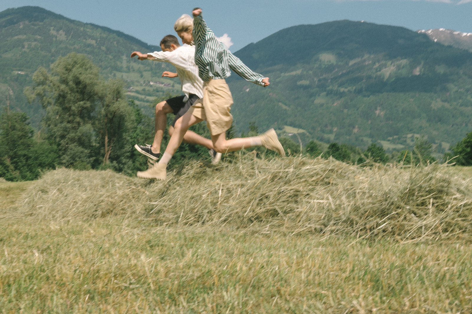 Students running through a mountain landscape